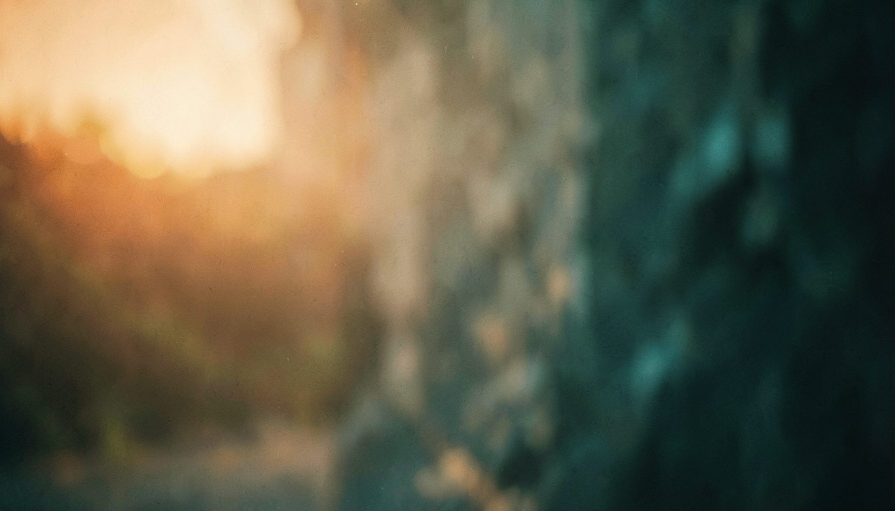 Warm cinematic still with soft amber and teal tones, evoking a reflective film atmosphere.