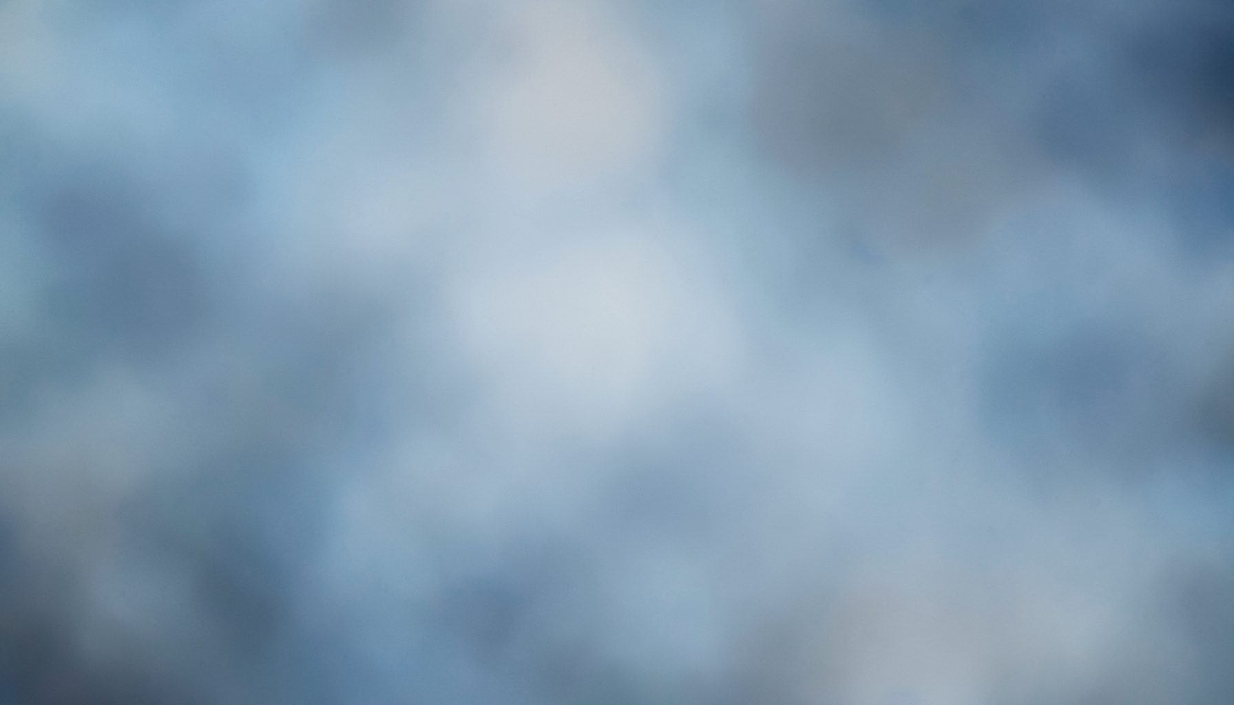 Soft-focus abstract backdrop in muted blues and grays, conveying a dreamy, lost-in-the-moment sensibility.