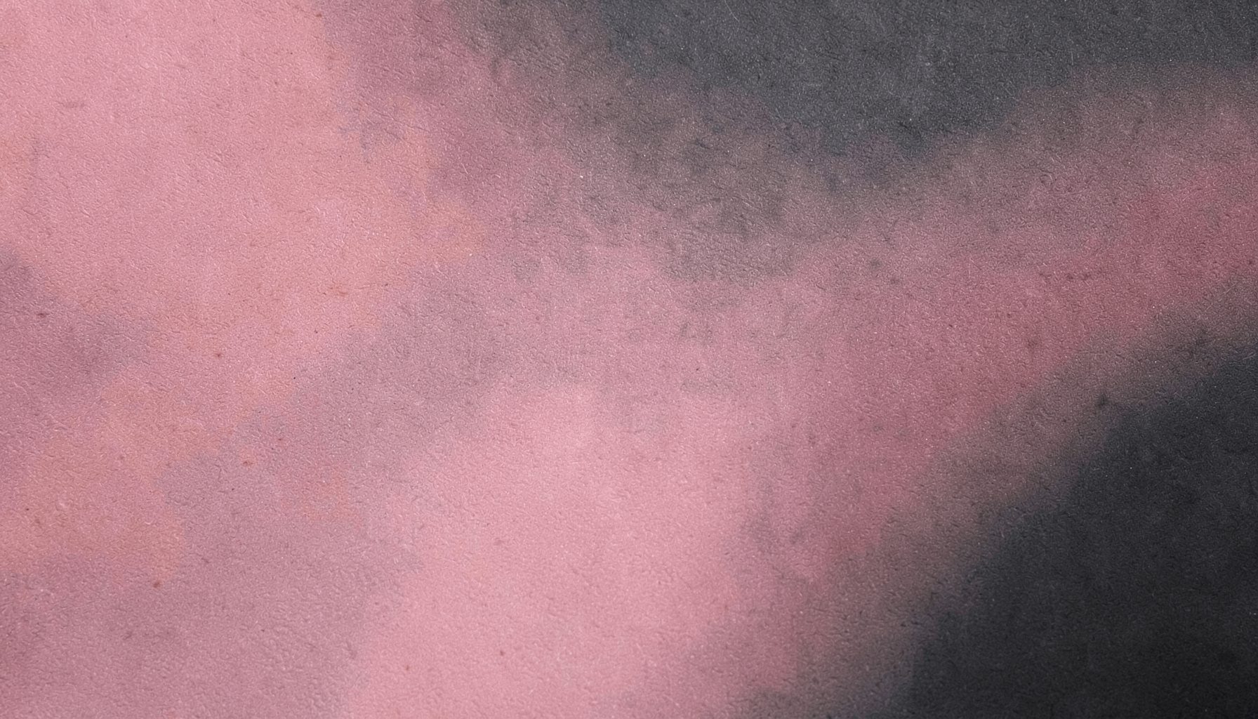 A textured surface with gentle gradients of rose and charcoal, subtle and emotionally resonant.